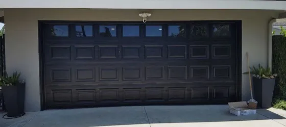 Modern black-frame glass garage door on a luxury Laguna Hills home