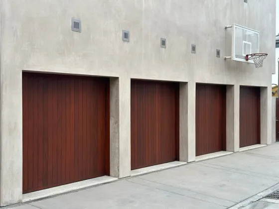 Row of four dark wood garage doors installed in Orange County