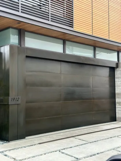 Vertical plank cedar garage door on a shingle-sided home — wood-look modern doors installed in Corona del Mar, CA