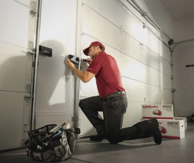Technician installing a gate access keypad with tools laid out — gate keypad repair in Orange County, CA