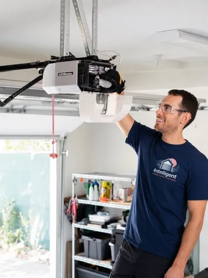 Technician mounting a garage door opener unit to the ceiling — opener installation in Orange County