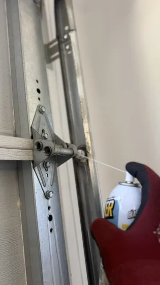 Technician performing garage door maintenance — free guides from Intelligent Garage Door & Gate Repair