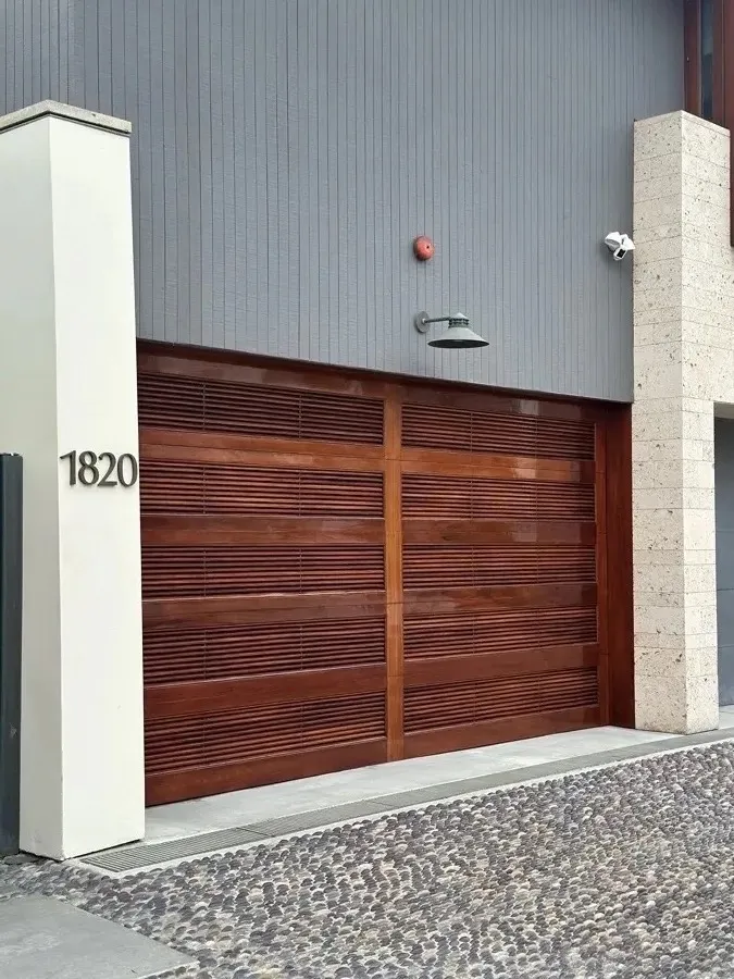 Horizontal-slat wood driveway gate installed at an Orange County home — driveway gate installation